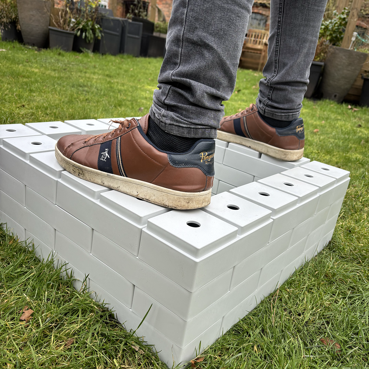 PolyBrick loading capacity as demonstrated by the weight of a man standing on top